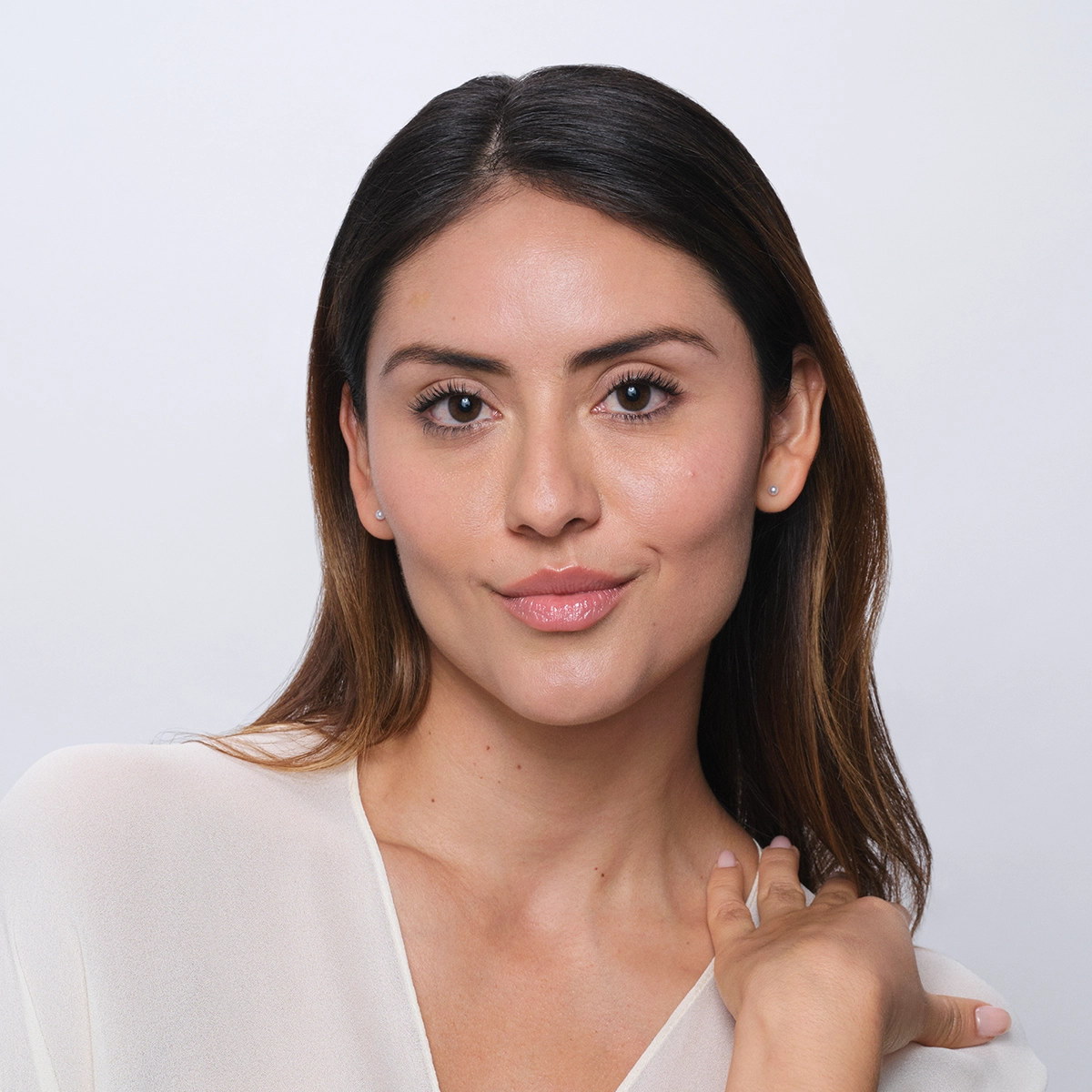 Woman smiling showing her healthy-looking skin.