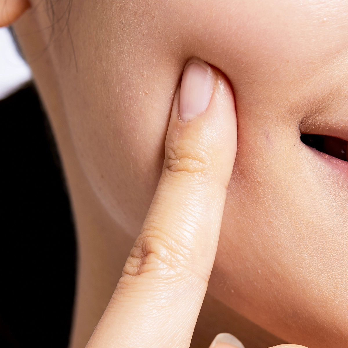 Woman touching face looking youthful.